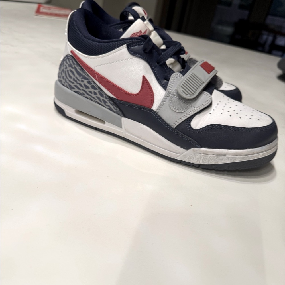 Nike Air Jordan Legacy 312 Low in the "Midnight Navy Varsity Red" colorway.
